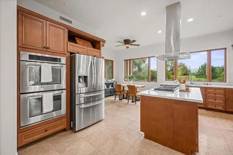 a large kitchen with a table and chairs