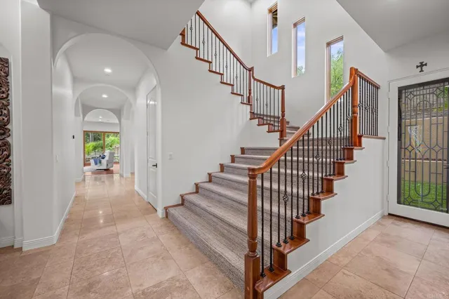 a large bathroom with a granite countertop double vanity sink a mirror and a bathtub