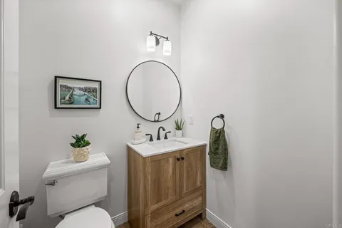 a bedroom with a large bed and a potted plant