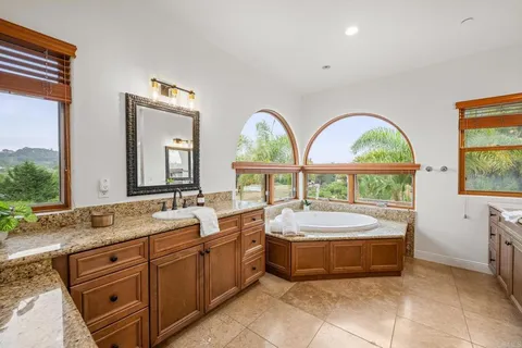 a bedroom with bed and a chandelier