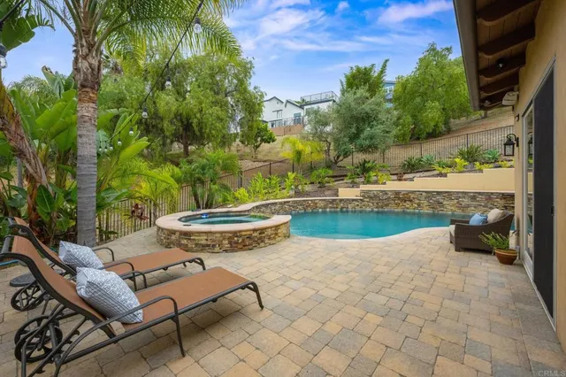 an aerial view of a house with a yard basket ball court and outdoor seating