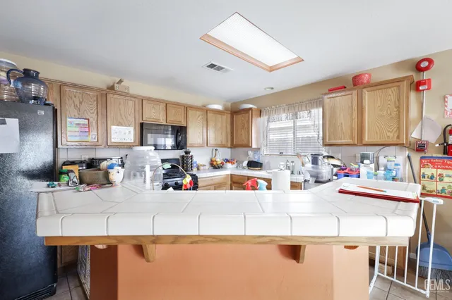 a dining room filled with lots of furniture and a chandelier