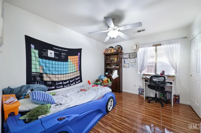 a bed room with bed and a chandelier