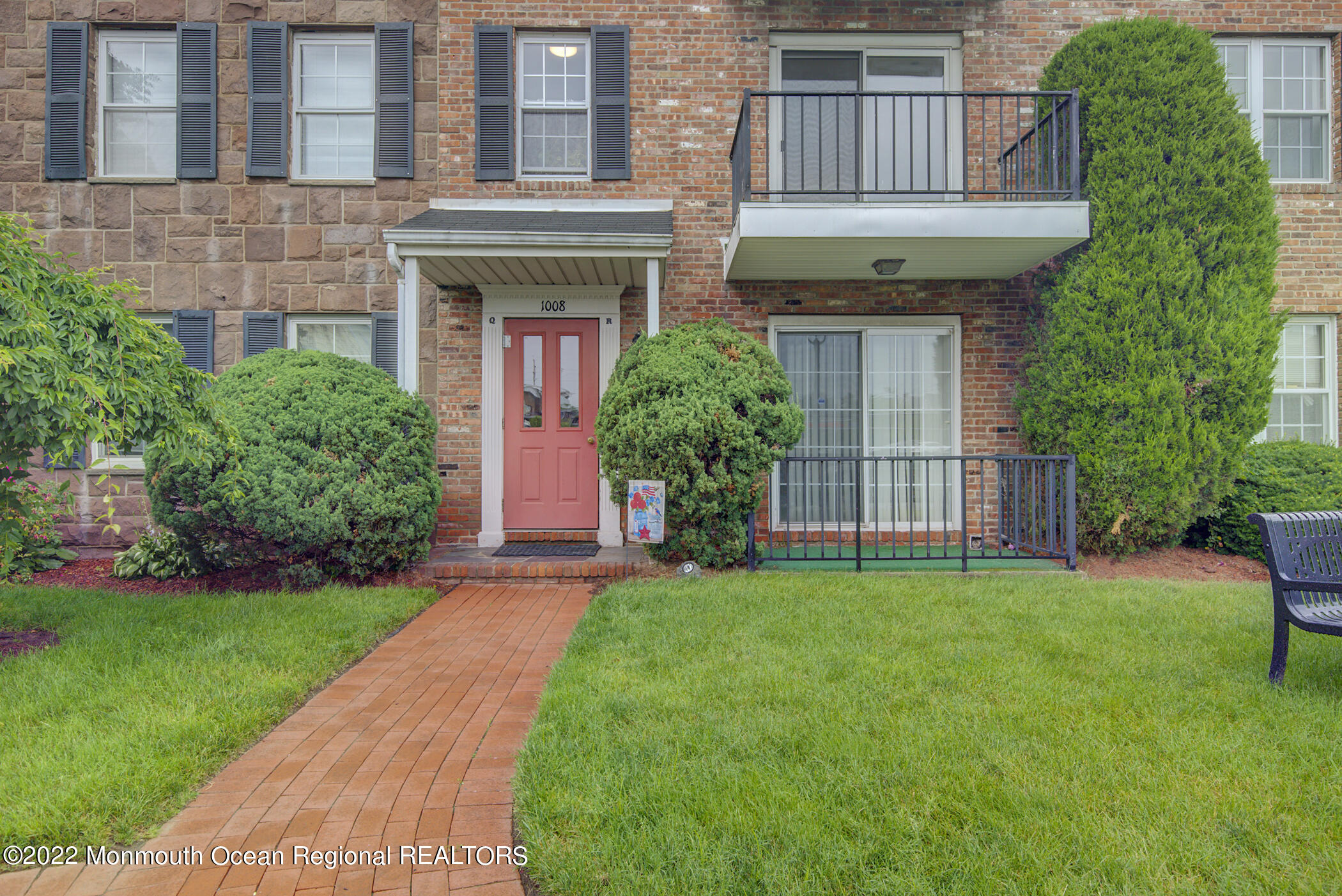 a view of a house with a garden and plants