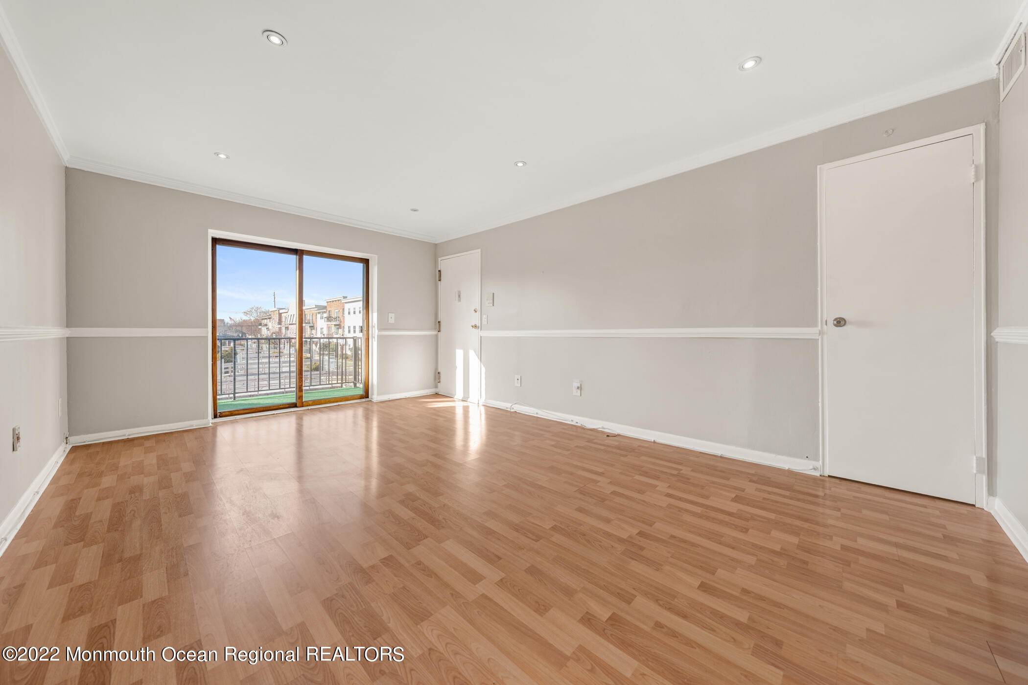 1008 Unicorn Way, Unit R002 Clifton, NJ 07011 - Photo 11 of 30 a view of an empty room with wooden floor and a window