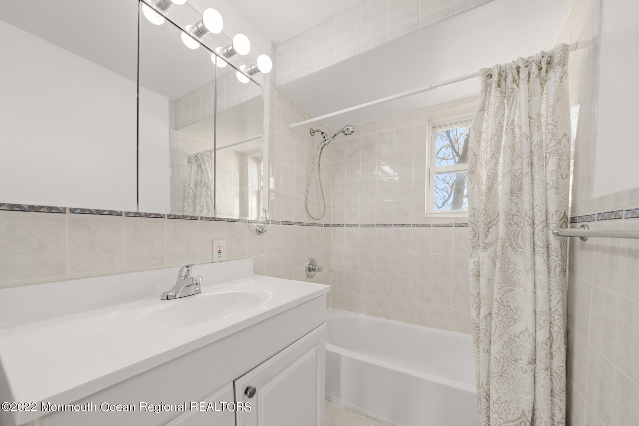 1008 Unicorn Way, Unit R002 Clifton, NJ 07011 - Photo 20 of 30 a bathroom with a sink a mirror and a shower