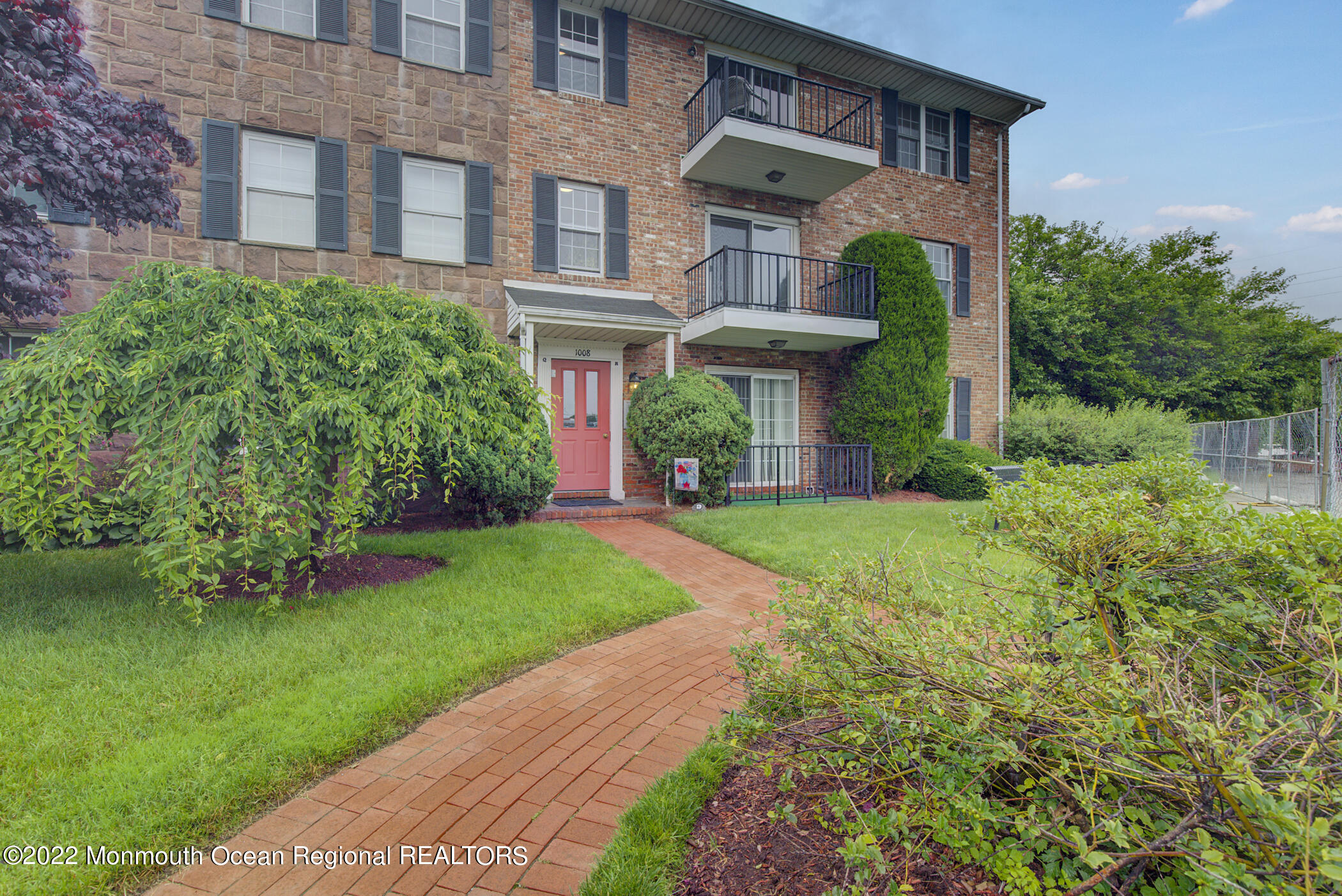 1008 Unicorn Way, Unit R002 Clifton, NJ 07011 - Photo 2 of 30 a view of a building with a yard