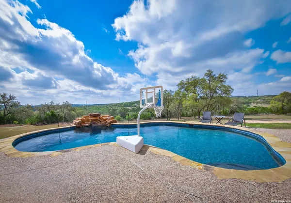a view of a patio with a table chairs and a backyard