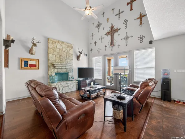 a living room with furniture kitchen view and a large window