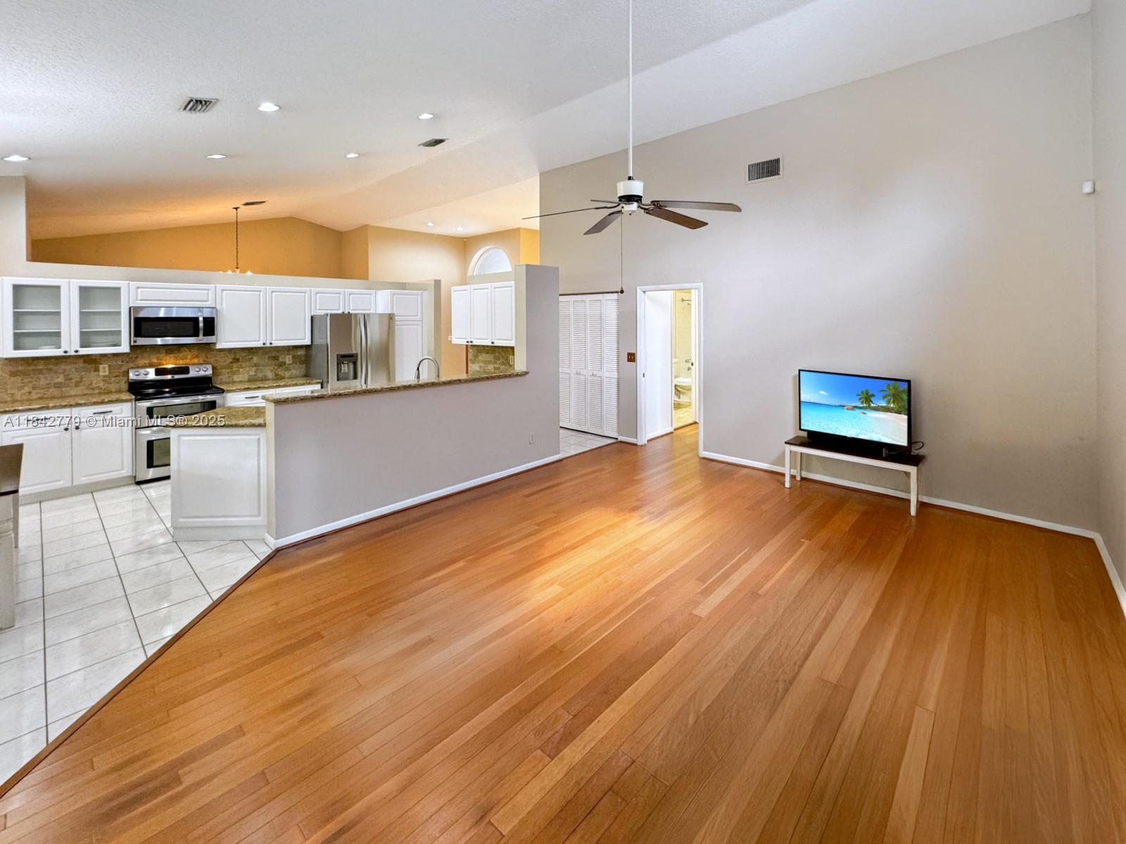 10621 Paris Street Cooper City, FL 33026 - Photo 19 of 58 a view of a kitchen with furniture and wooden floor