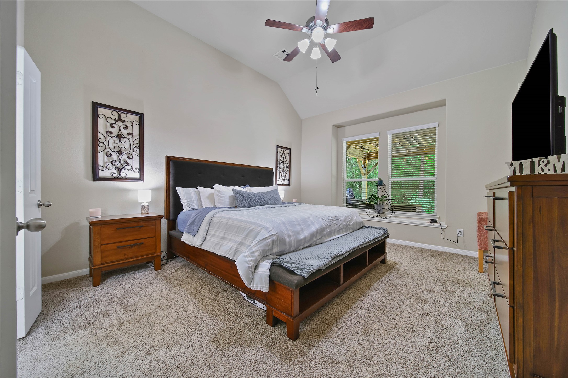 9223 Wapiti Trail Conroe, TX 77303 - Photo 23 of 45 a bedroom with a bed flat screen tv and a window