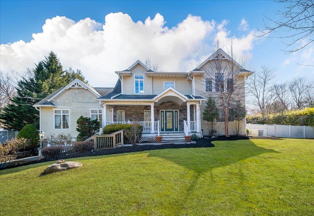a front view of house with yard and green space