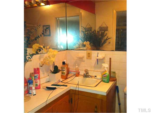2620 Old Williams Road Raleigh, NC 27610 - Photo 9 of 17 a bathroom with a sink and mirror