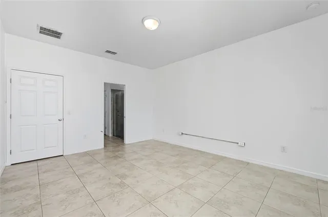 a spacious bathroom with a double vanity sink a mirror and a shower