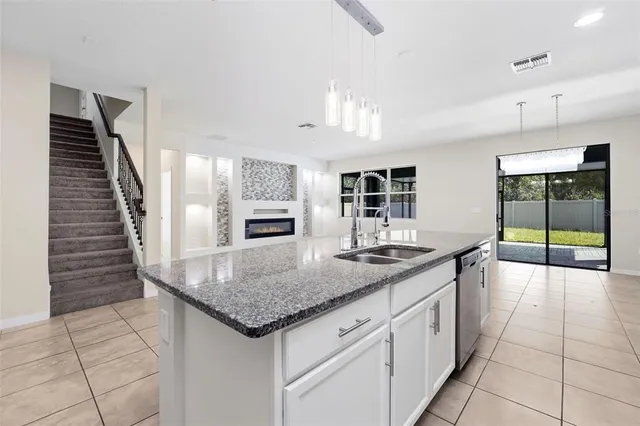 a kitchen with granite countertop a sink and a stove