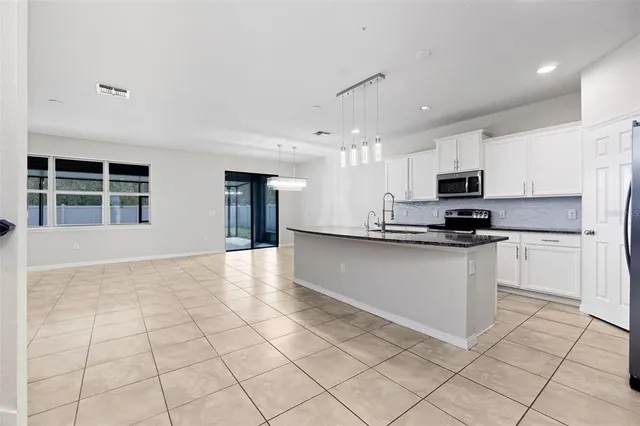 a kitchen with stainless steel appliances granite countertop a refrigerator sink and cabinets