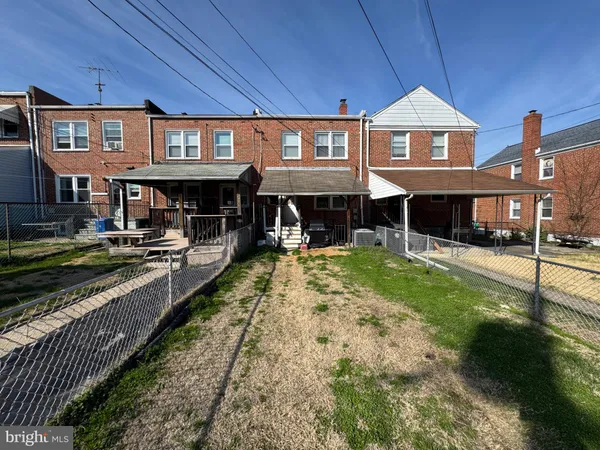 a view of a big house with swimming pool and sitting area