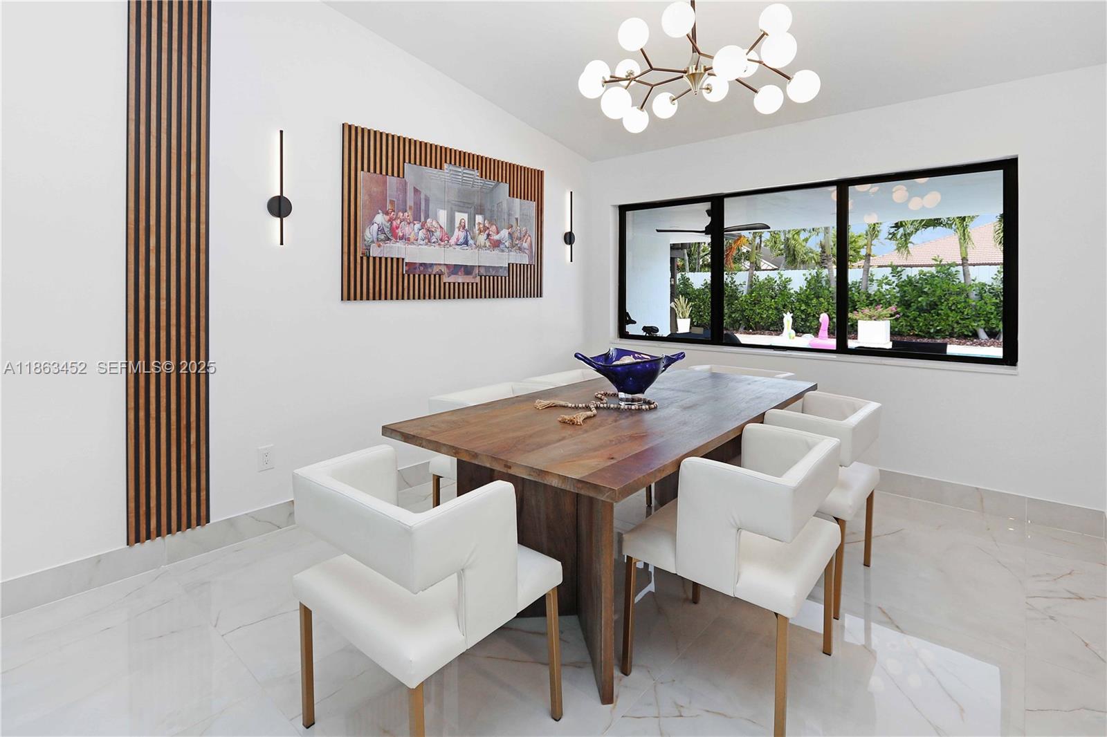 14211 Southwest 31st Street Miami, FL 33175 - Photo 11 of 27 a view of a dining room with furniture a large window and a livingroom