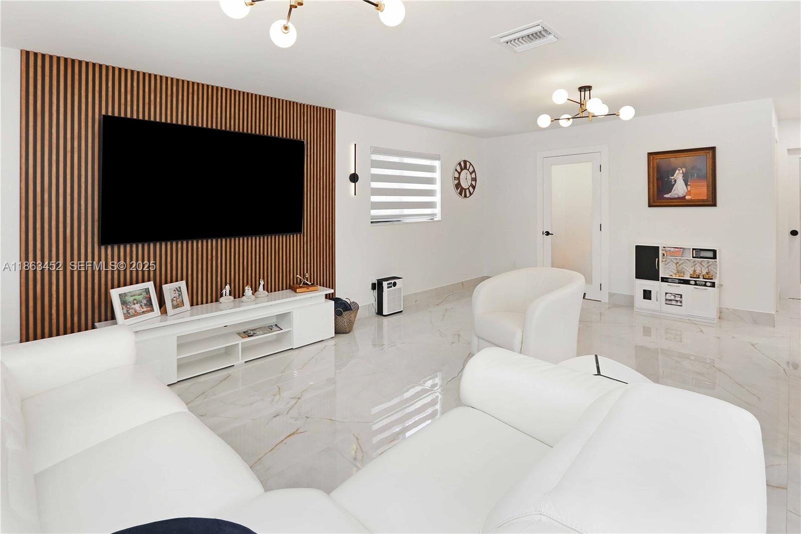 14211 Southwest 31st Street Miami, FL 33175 - Photo 13 of 27 a living room with furniture and a flat screen tv