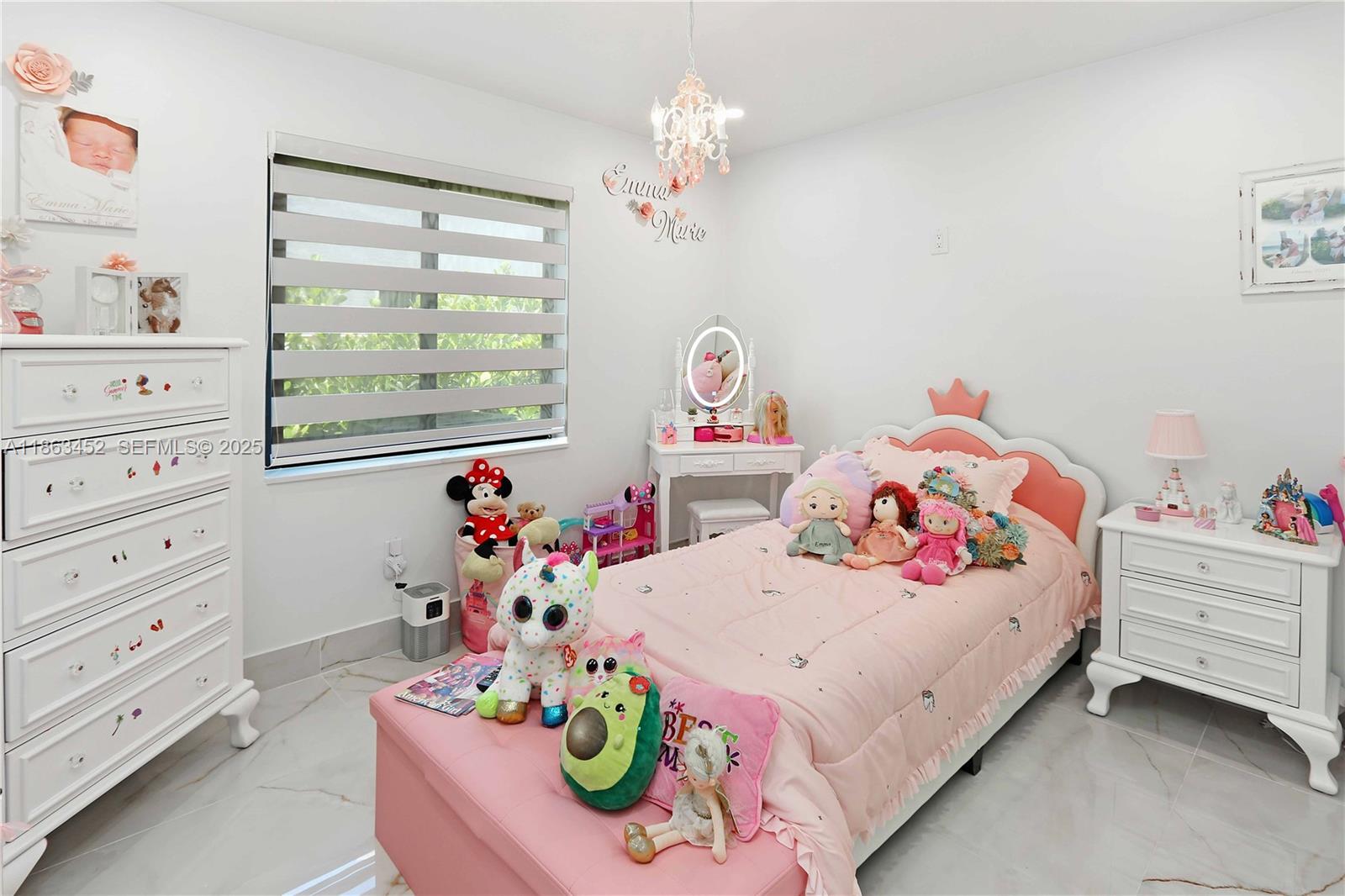 14211 Southwest 31st Street Miami, FL 33175 - Photo 19 of 27 a bedroom with a bed and chandelier