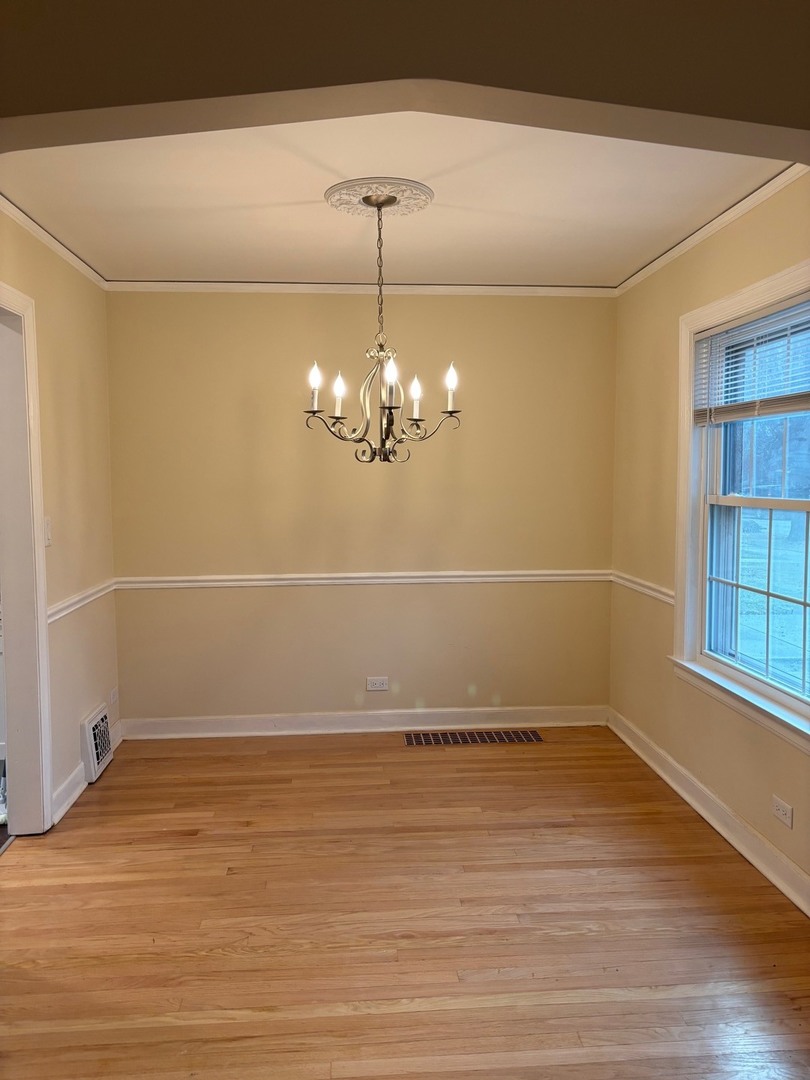 2003 Newton Avenue Park Ridge, IL 60068 - Photo 4 of 21 a view of a room with wooden floor chandelier and window