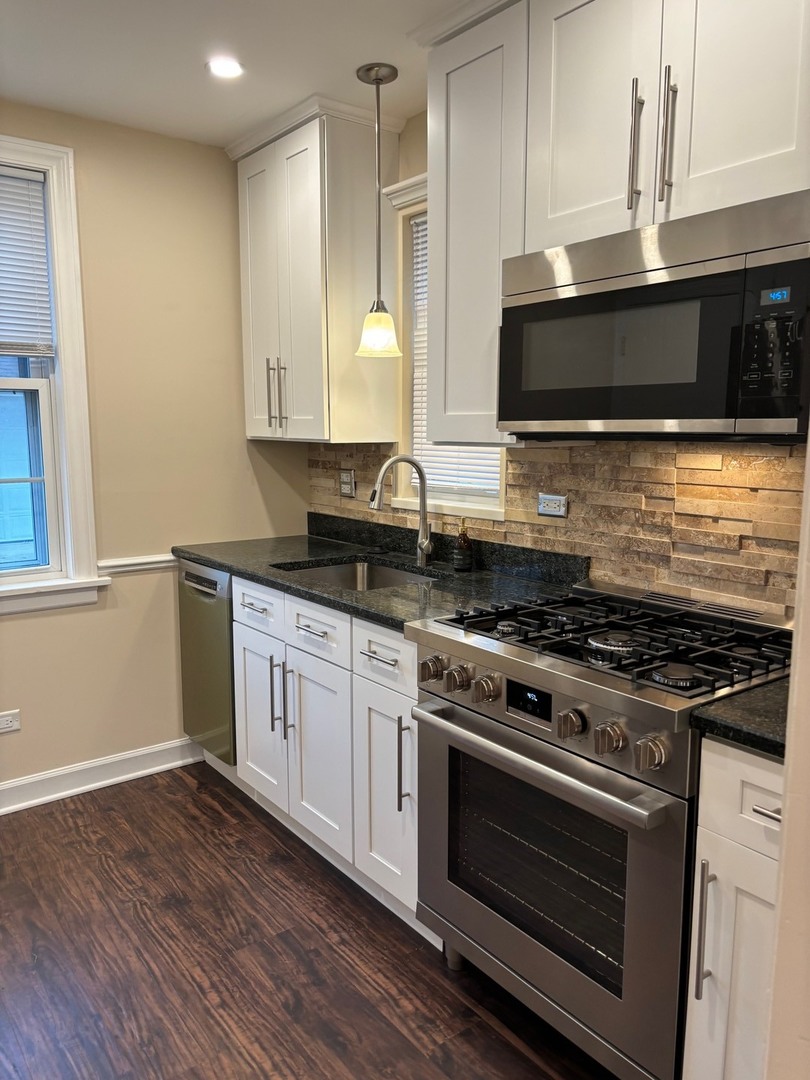 2003 Newton Avenue Park Ridge, IL 60068 - Photo 5 of 21 a kitchen with stainless steel appliances a stove a microwave and cabinets
