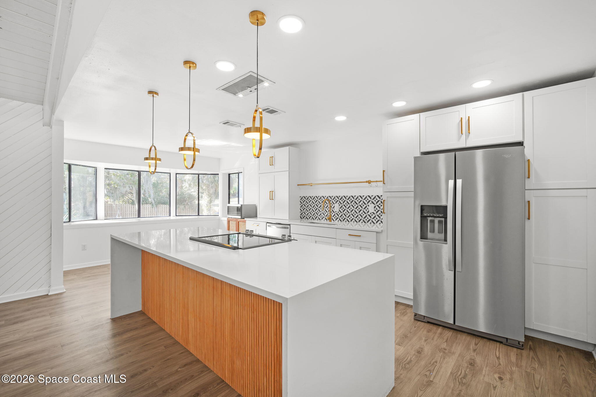 470 South Carpenter Road Titusville, FL 32796 - Photo 12 of 55 a kitchen with stainless steel appliances granite countertop a sink a refrigerator and a counter top space