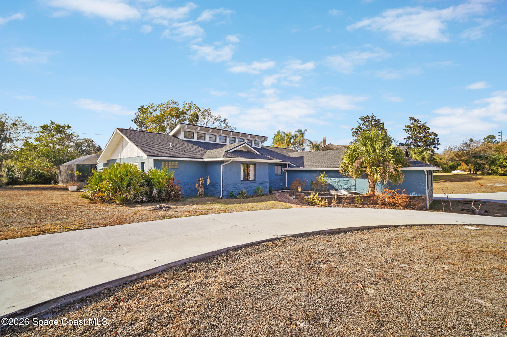 470 South Carpenter Road Titusville, FL 32796 - Photo 7 of 55 a front view of a house with a yard and a garage