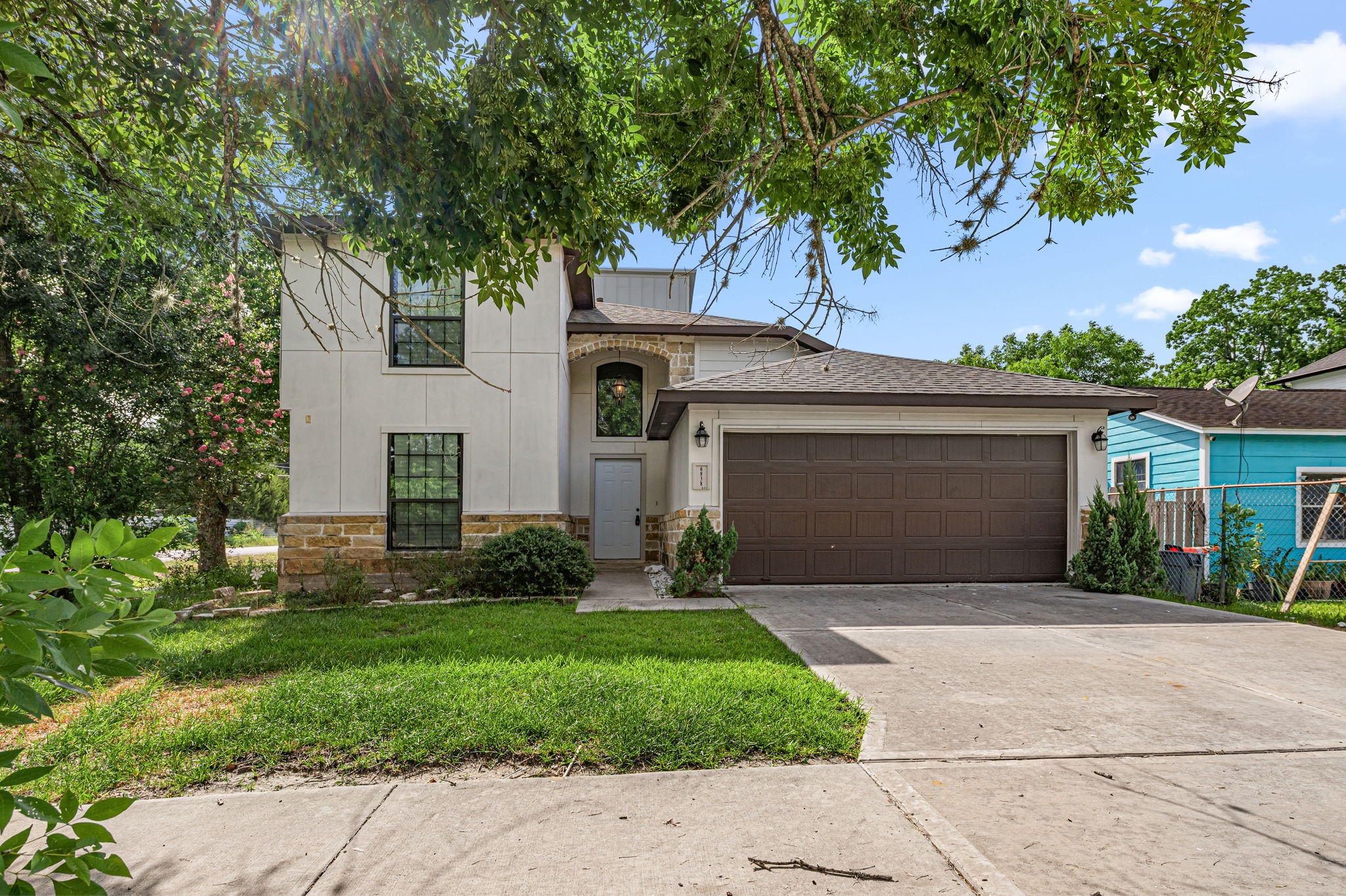 6838 Foster Street Houston, TX 77021 - Photo 1 of 24 Front exterior view of this two-story home with mature shade trees and an attached two-car garage