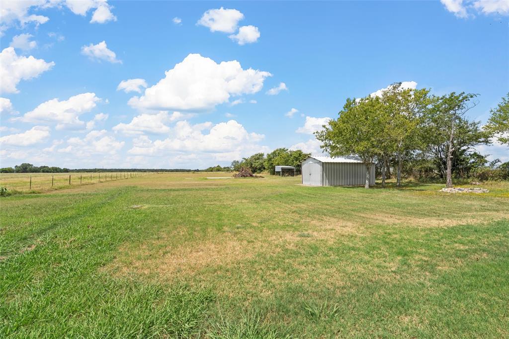 3433 West Tours Road West, TX 76691 - Photo 36 of 40 View of yard with an outbuilding, a pole building, and a view of rural / pastoral area