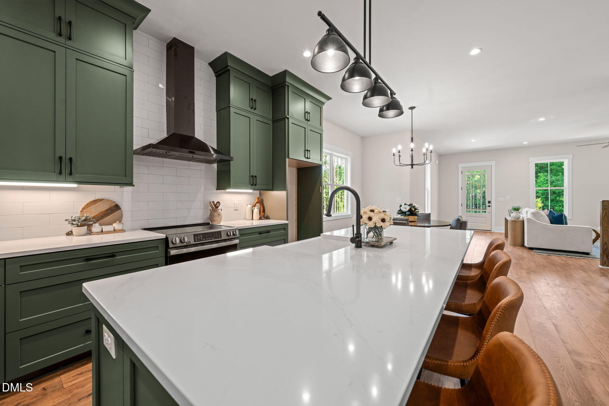 400 Pilot Ridge Road Zebulon, NC 27597 - Photo 14 of 51 a large kitchen with stainless steel appliances a stove a sink dishwasher a dining table and chairs with wooden floor