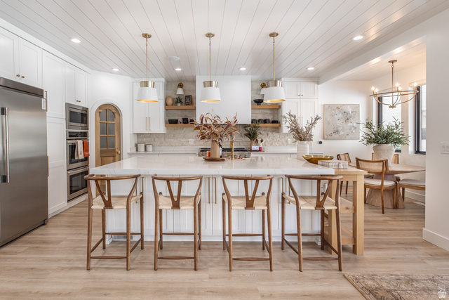 1276 West Fallow Way, Unit 76 Ogden, UT 84414 - Photo 3 of 22 Kitchen featuring open shelves, white cabinets, stainless steel appliances, light wood finished floors, and wood ceiling
