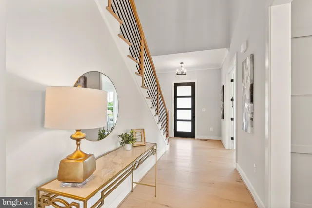 a dining room with stainless steel appliances furniture a rug kitchen view and a chandelier