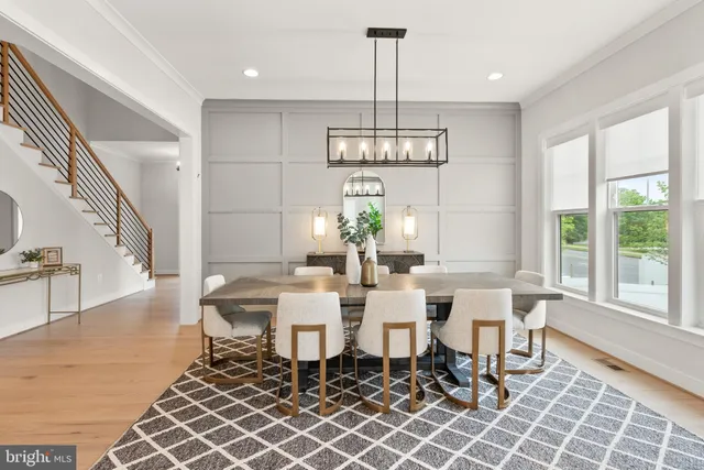 a kitchen with stainless steel appliances kitchen island granite countertop a table chairs and a refrigerator