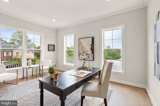 a view of a dining room and livingroom with furniture wooden floor a chandelier
