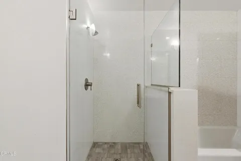 a bathroom with a shower and a glass door