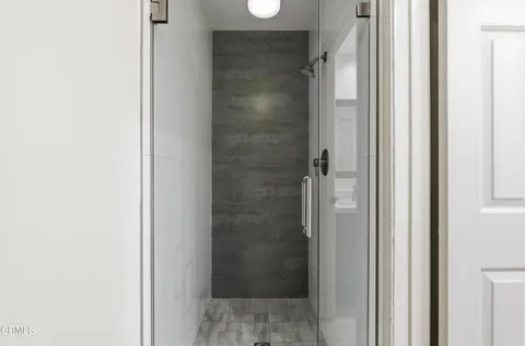 a bathroom with a glass shower door