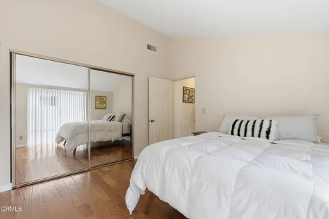 a bedroom with a bed and a large mirror