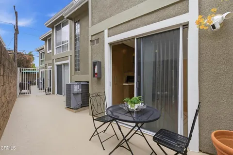 a view of a balcony and table and chairs