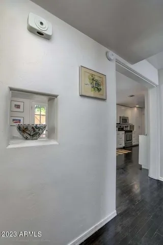 a view of a hallway to a livingroom with furniture
