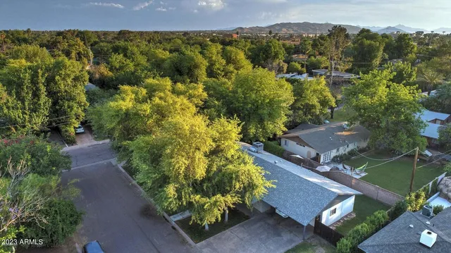 an aerial view of a house with a yard