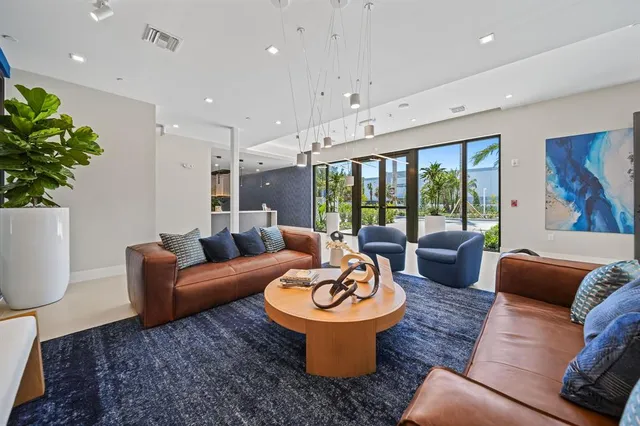 a living room with furniture a lamp and a potted plant