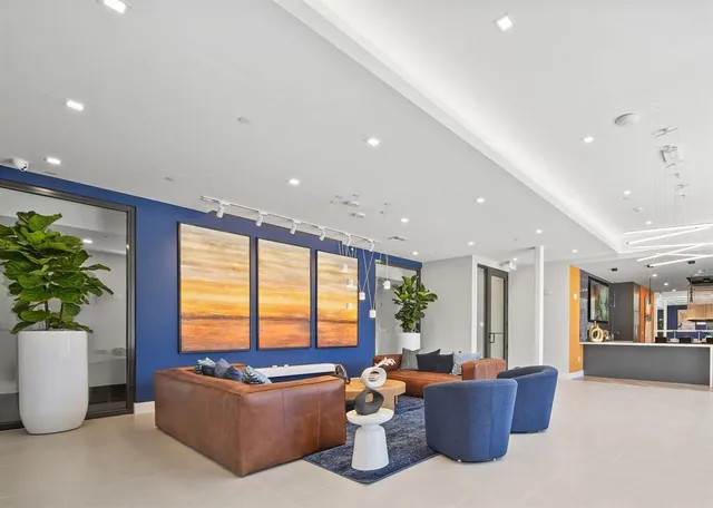 a living room with furniture and a potted plant