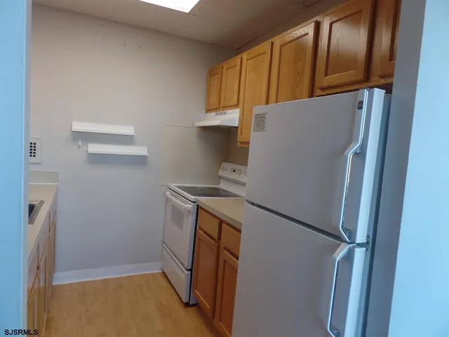 a kitchen with a sink cabinets and a window