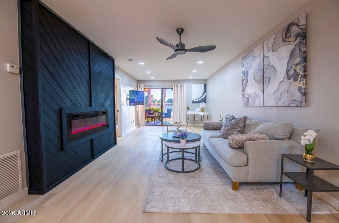 4303 East Cactus Road, Unit 128 Phoenix, AZ 85032 - Photo 2 of 39 a living room with furniture and a ceiling fan