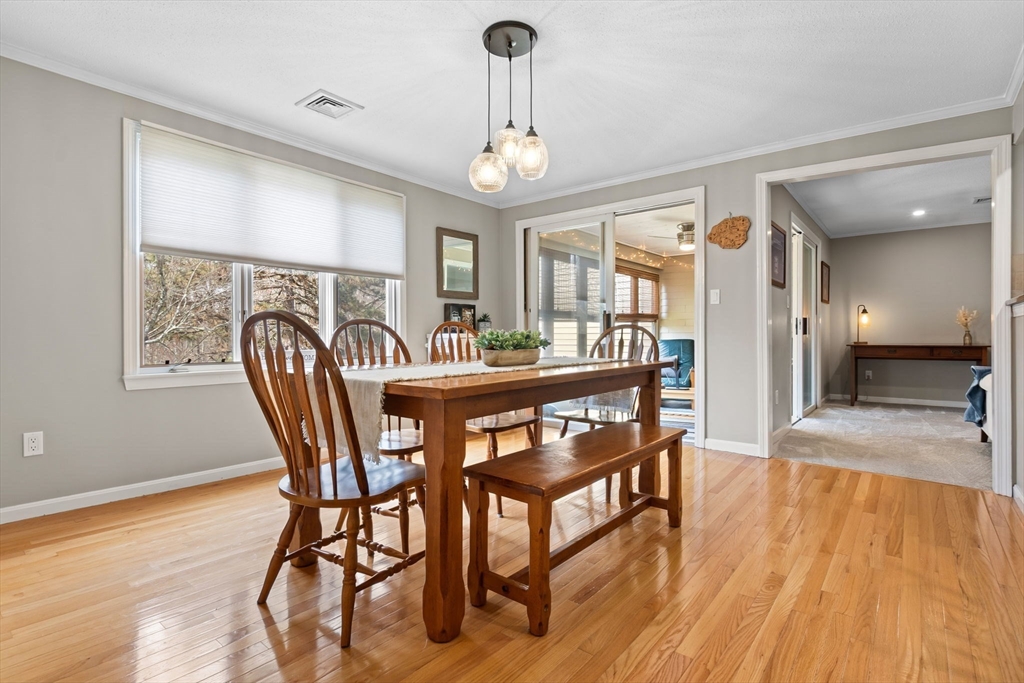 167 Village Post Road, Unit 167 Danvers, MA 01923 - Photo 16 of 42 a dining room with furniture a chandelier and wooden floor