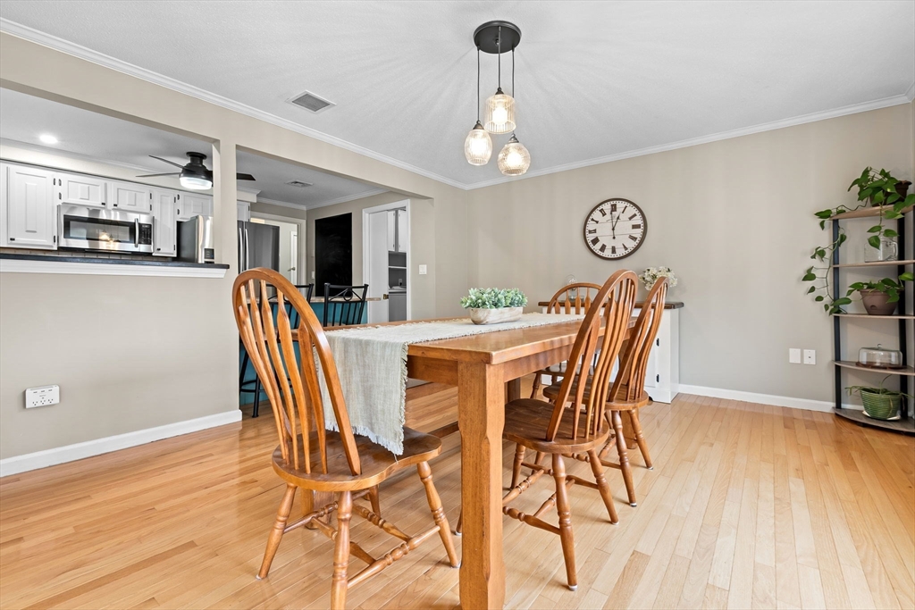 167 Village Post Road, Unit 167 Danvers, MA 01923 - Photo 17 of 42 a view of a dining room with furniture and wooden floor