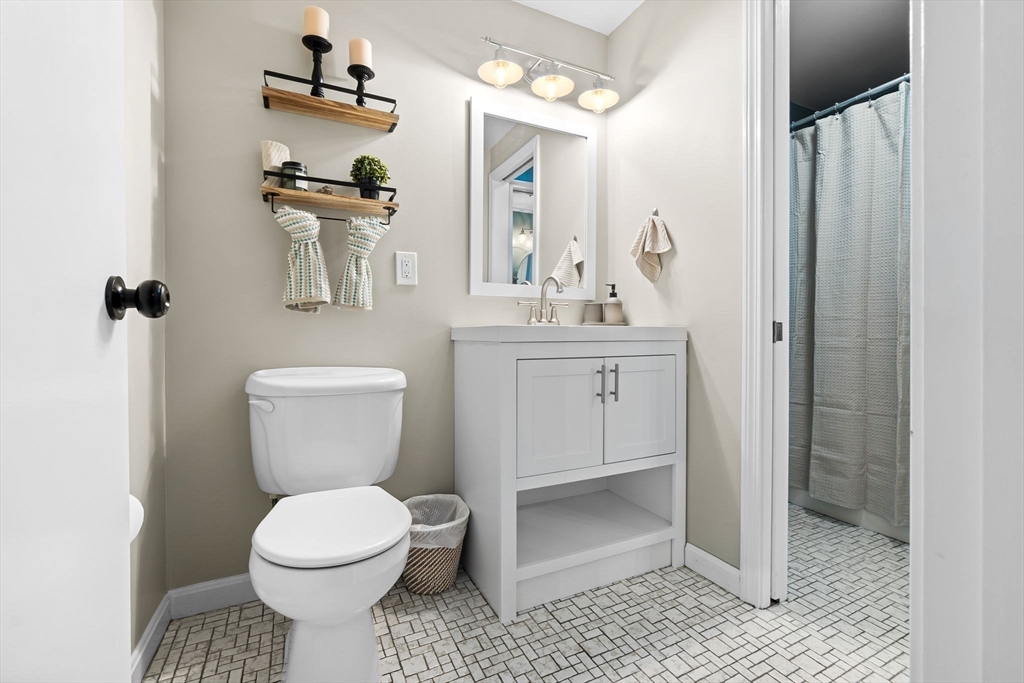 167 Village Post Road, Unit 167 Danvers, MA 01923 - Photo 18 of 42 a bathroom with a toilet a sink and mirror