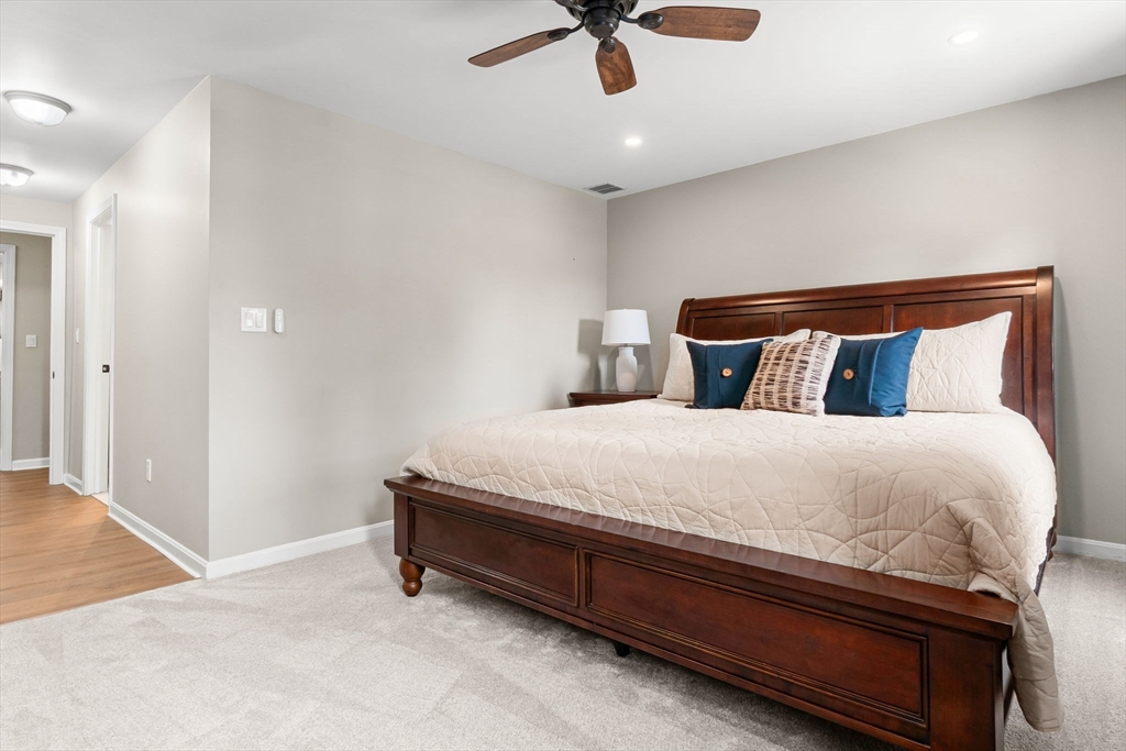 167 Village Post Road, Unit 167 Danvers, MA 01923 - Photo 23 of 42 a large bed sitting in a room next to a window
