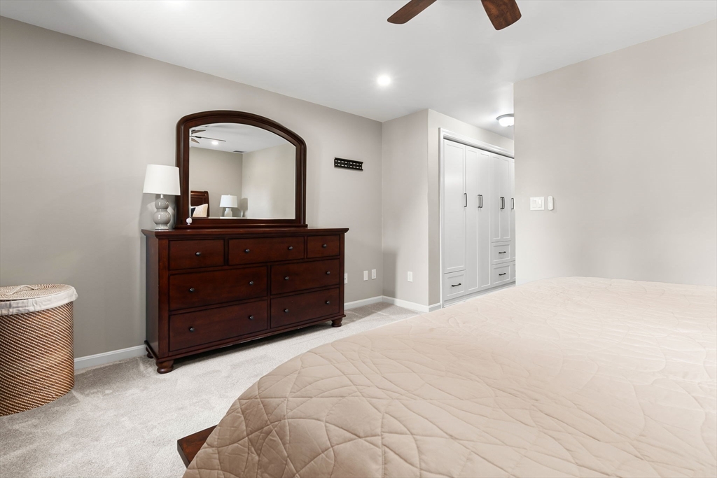 167 Village Post Road, Unit 167 Danvers, MA 01923 - Photo 24 of 42 a bedroom with a bed and a dresser